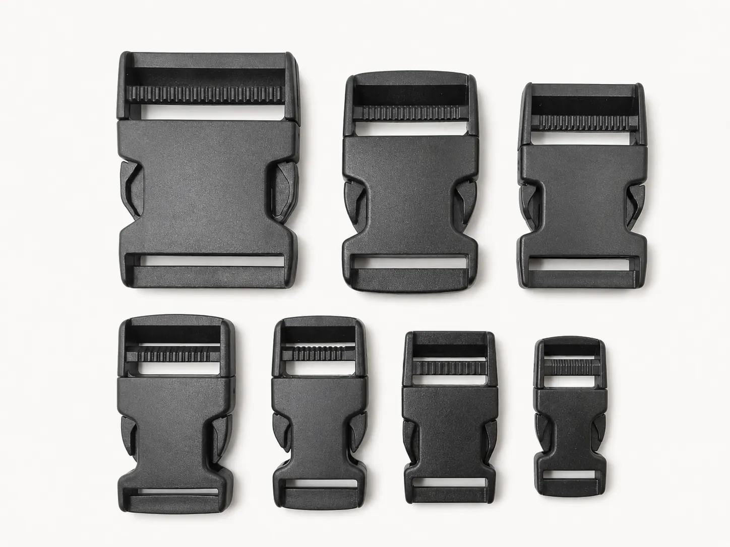Standard plastic side release buckles shown in a size range from large to small