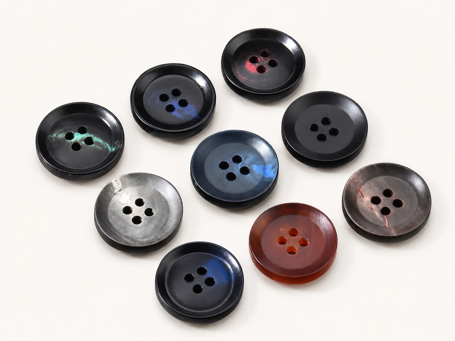 polished dark horn buttons with subtle iridescent blue green red and smoky tones