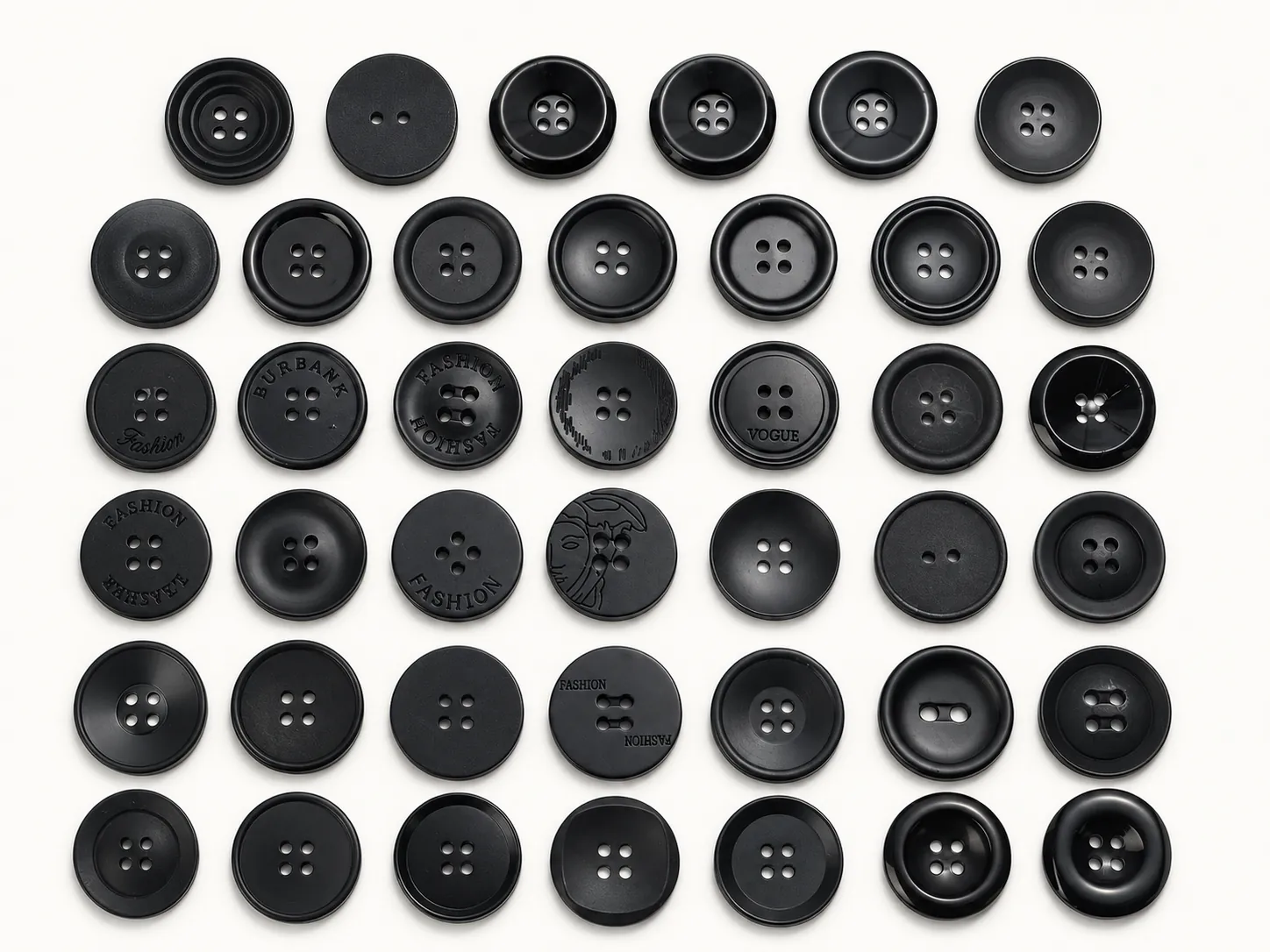 Black matte logo buttons sample board with assorted rim profiles and finishes